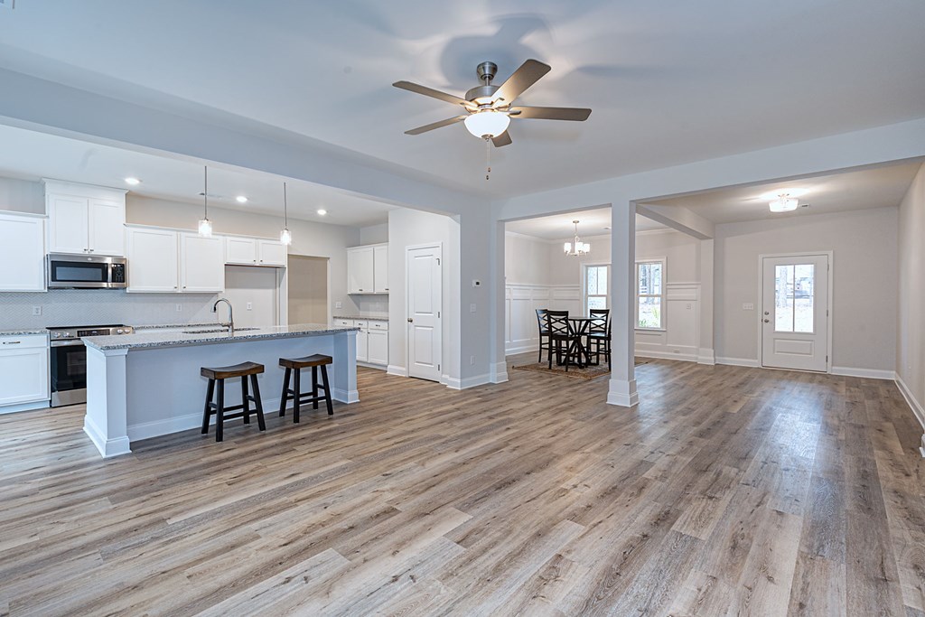 8711 McKee Road Upatoi, GA 31829 - Photo 9 of 45 a view of kitchen with cabinets and wooden floor