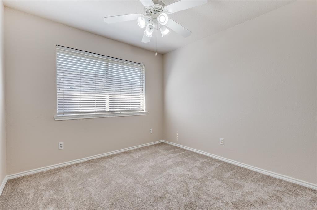 2606 Whetstone Drive Corinth, TX 76210 - Photo 15 of 28 an empty room with a window and a fan