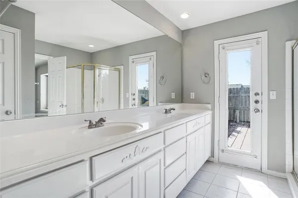 a bathroom with a sink double vanity and a shower