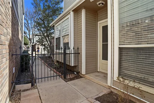 a view of a house with backyard and wooden fence