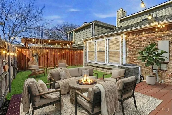 a backyard of a house with table and chairs