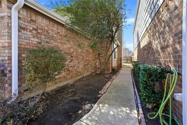 a pathway of a house with backyard