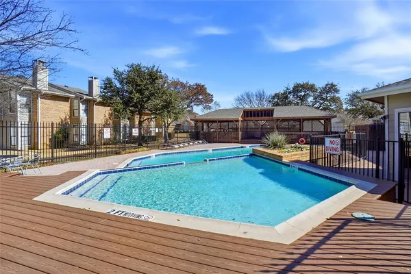 a view of a swimming pool with outdoor seating