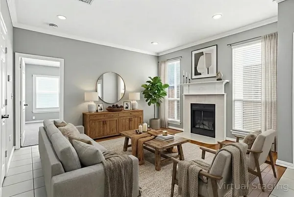 a living room with furniture fireplace and a large window