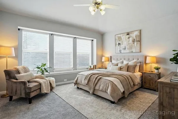 a spacious bedroom with a bed and a couch