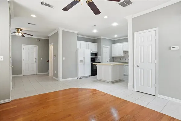 a view of a kitchen with refrigerator and a ceiling fan