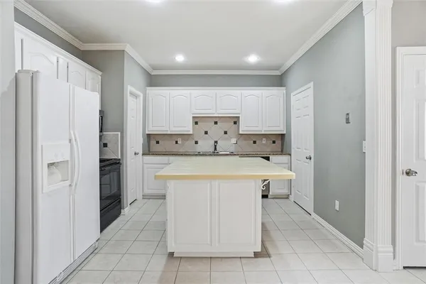 a large kitchen with cabinets and stainless steel appliances