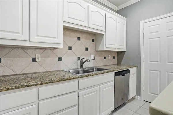 a kitchen with stainless steel appliances granite countertop a sink and cabinets