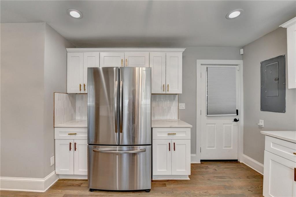 2945 Monterey Drive Decatur, GA 30032 - Photo 34 of 93 a kitchen with white cabinets and stainless steel appliances