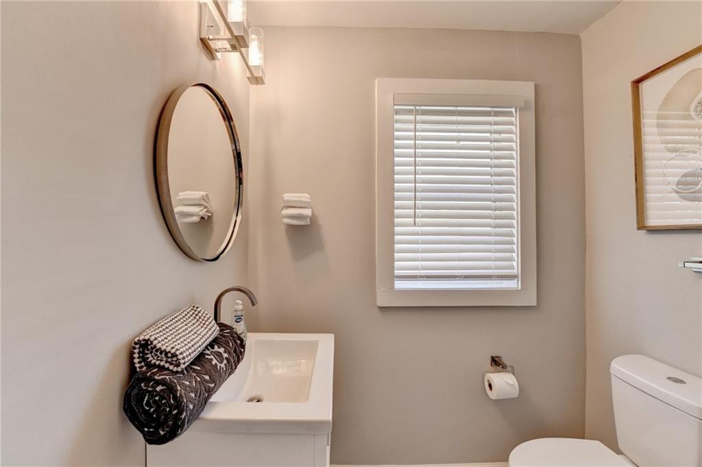 2945 Monterey Drive Decatur, GA 30032 - Photo 48 of 93 a bathroom with a toilet a mirror and a window