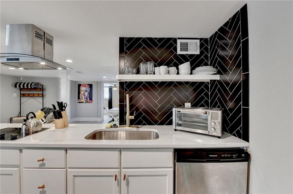 2945 Monterey Drive Decatur, GA 30032 - Photo 61 of 93 a kitchen with a sink a refrigerator and cabinets
