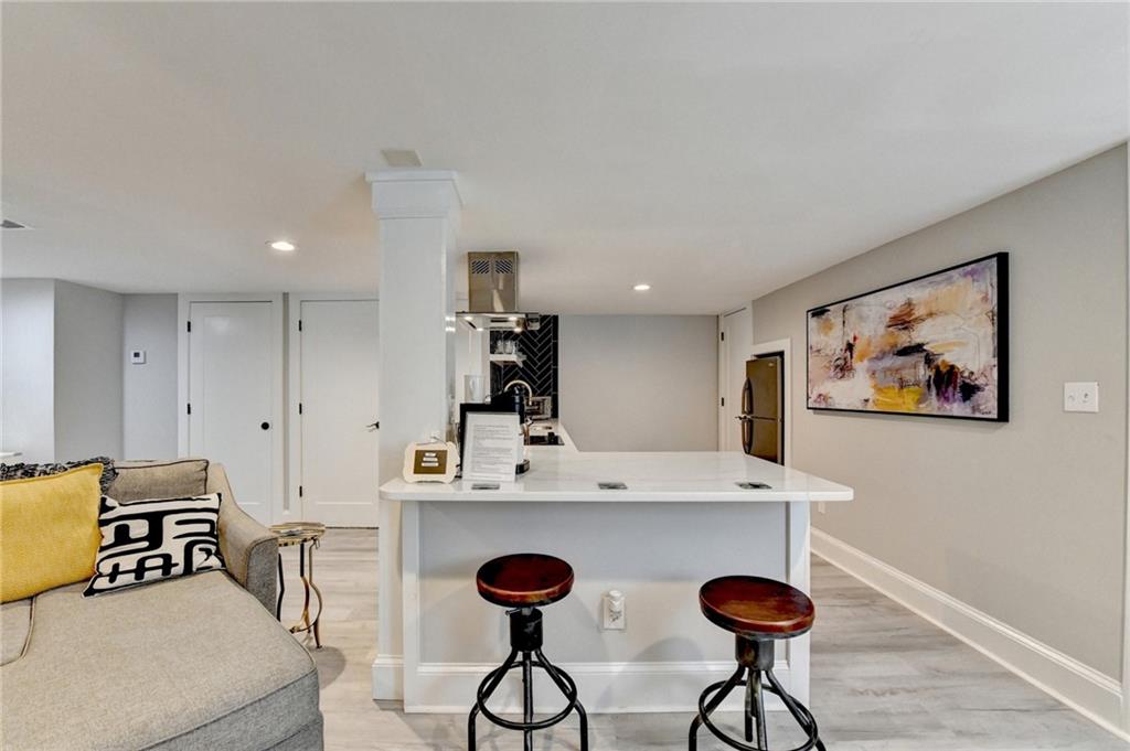 2945 Monterey Drive Decatur, GA 30032 - Photo 66 of 93 a view of kitchen with stainless steel appliances granite countertop a stove a sink a dining table and chairs with wooden floor