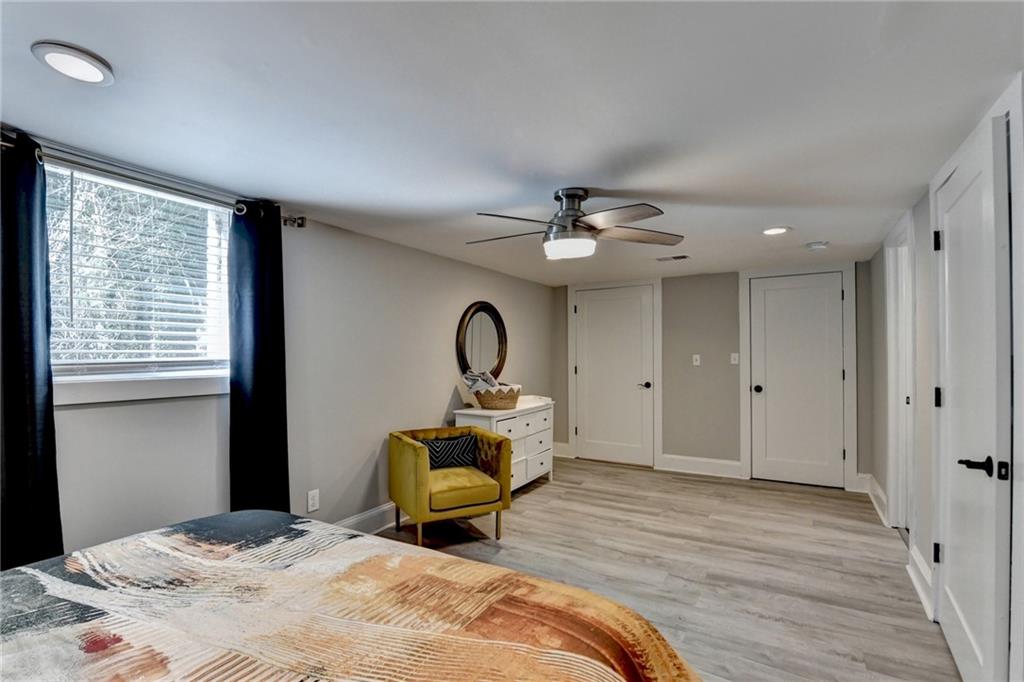 2945 Monterey Drive Decatur, GA 30032 - Photo 78 of 93 a spacious bedroom with a bed a chandelier and a window