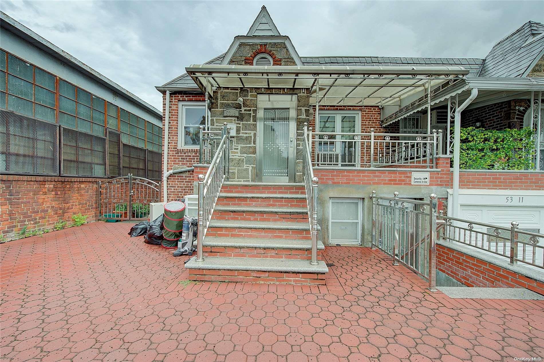 53-09 37th Road Queens, NY 11377 - Photo 1 of 1 a front view of a house with a yard