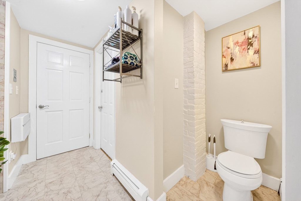 352 Tappan Street, Unit 1 Brookline, MA 02445 - Photo 19 of 42 a bathroom with a toilet and a shower curtain