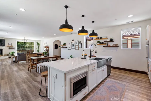 a view of a white house with a yard and large tree