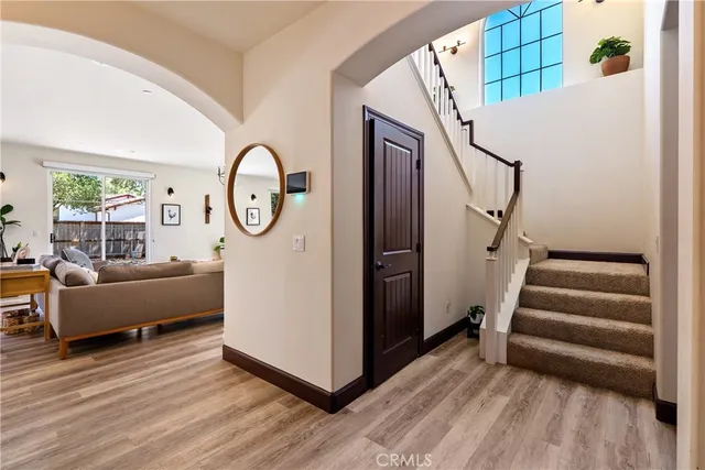 a living room with furniture fireplace and a large window