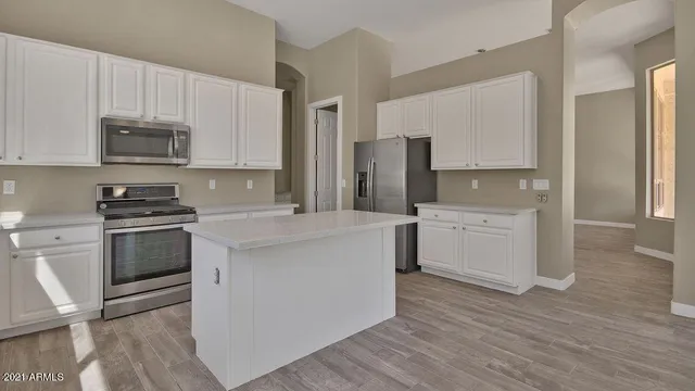 a kitchen with stainless steel appliances a stove a sink refrigerator and cabinets