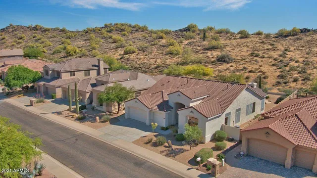 an aerial view of houses with a street
