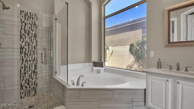 a bathroom with a bathtub and shower