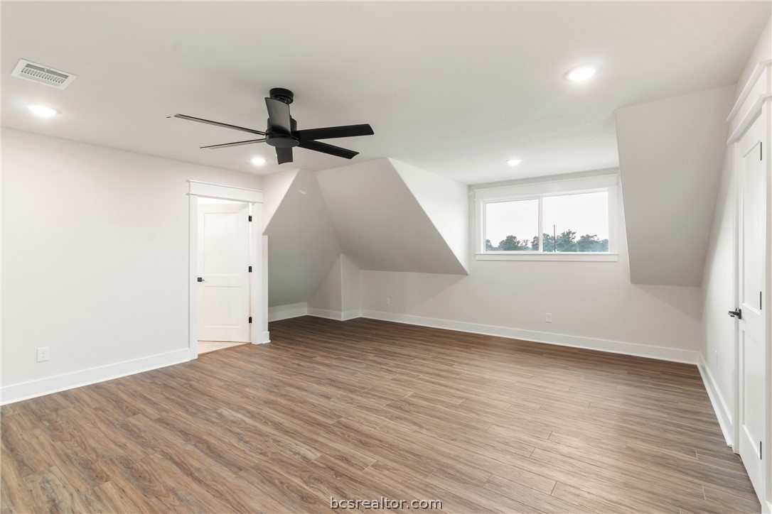 7822 Mathis Crk Drive Bryan, TX 77808 - Photo 30 of 43 wooden floor in an empty room with a window
