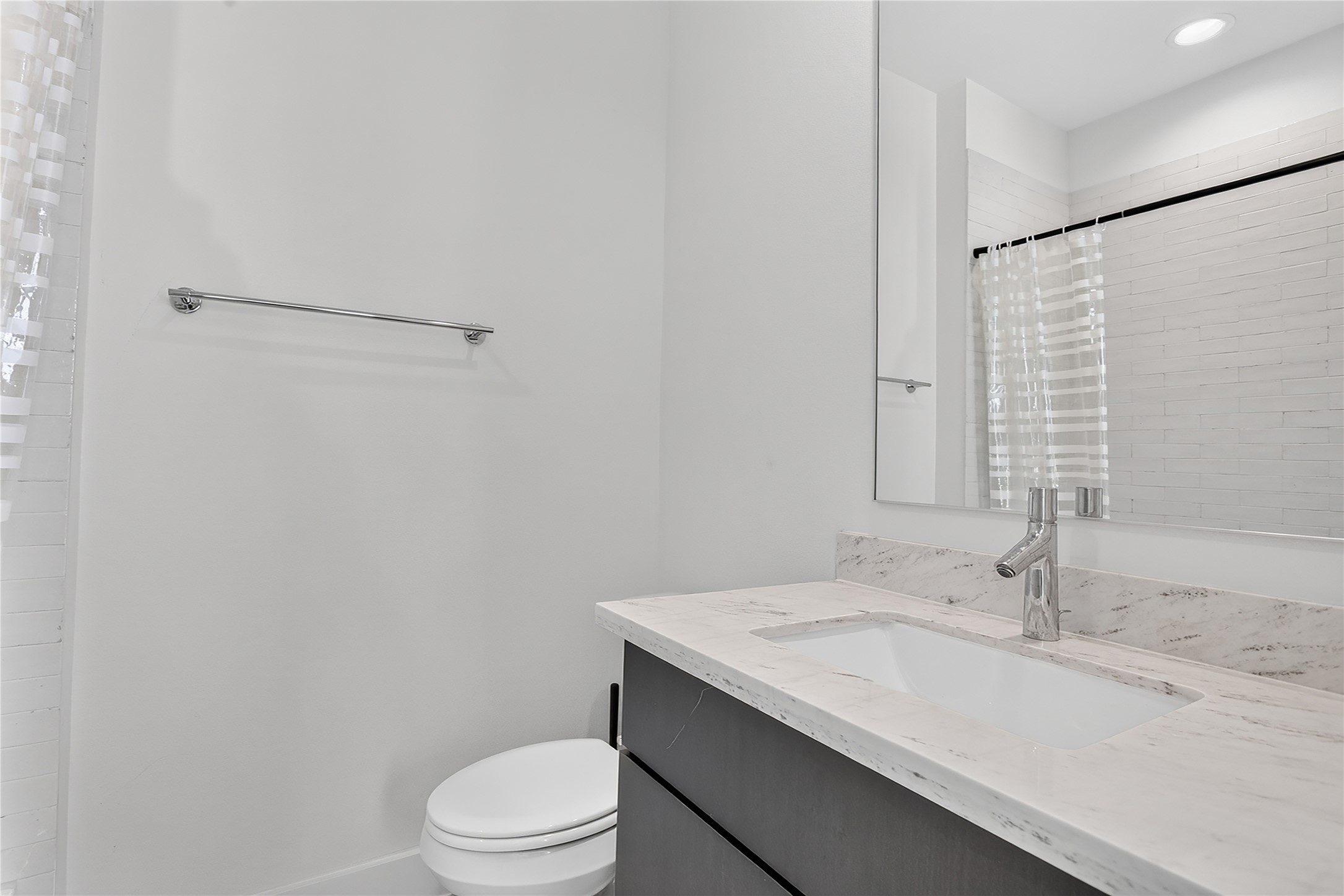 2805 McCurdy Street, Unit 14 Austin, TX 78723 - Photo 20 of 40 A refined bathroom featuring a contemporary vanity with a gleaming countertop and modern fixtures.