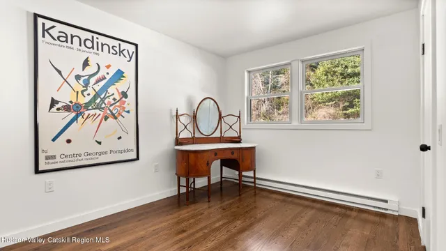 a view of a livingroom with furniture window and wooden floor