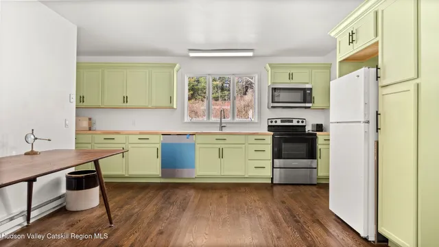 a kitchen with a stove a sink and a refrigerator