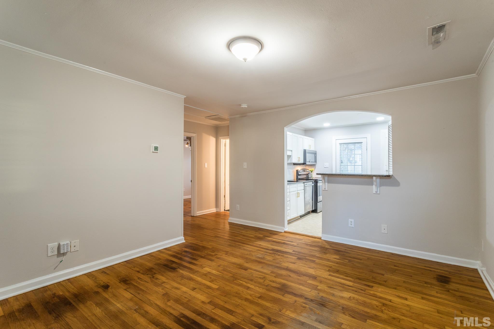 2620 McNeil Street, Unit 2620 Raleigh, NC 27608 - Photo 12 of 23 a view of a room with wooden floor and a window