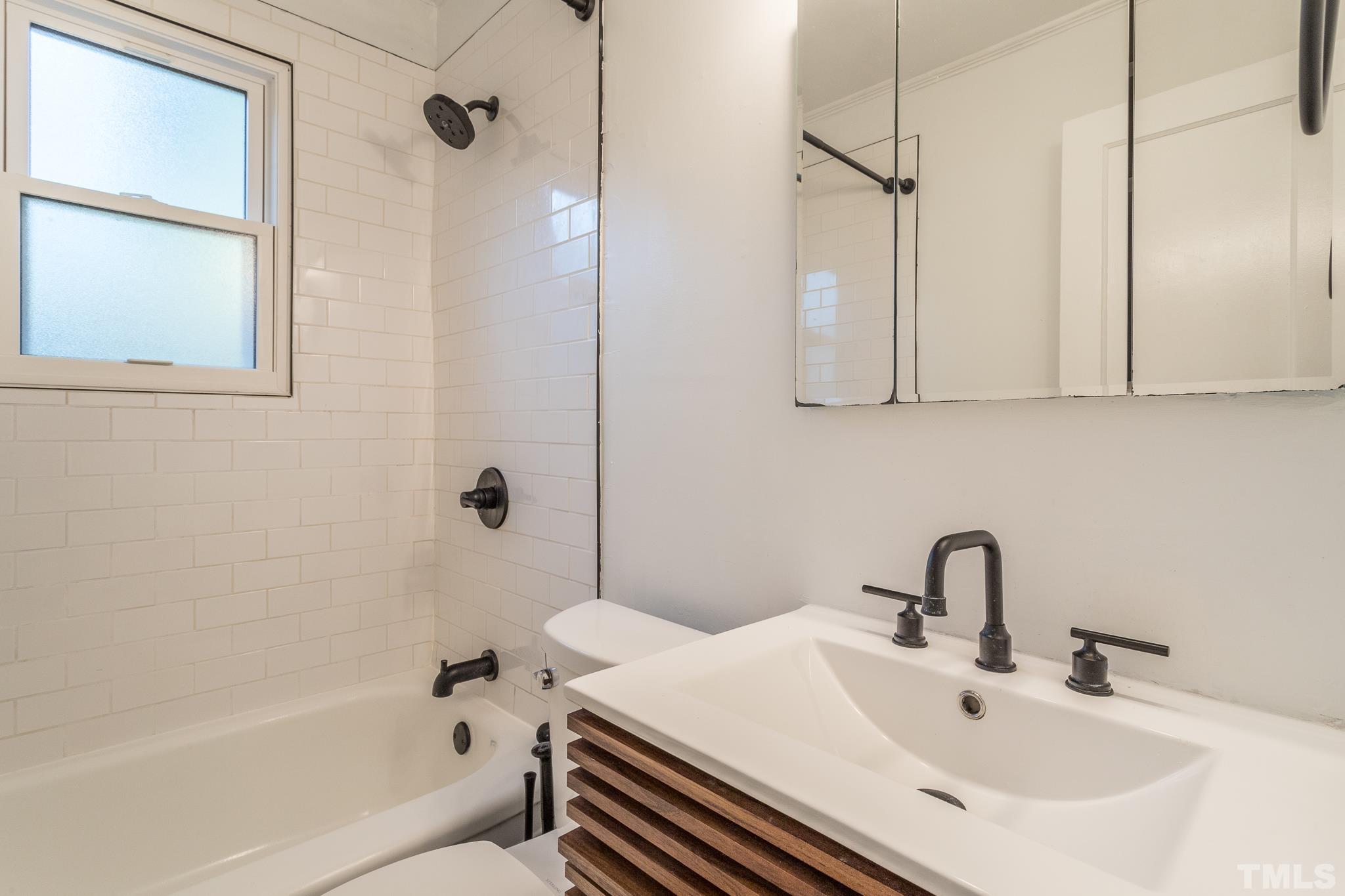 2620 McNeil Street, Unit 2620 Raleigh, NC 27608 - Photo 14 of 23 a bathroom with a sink and a bathtub