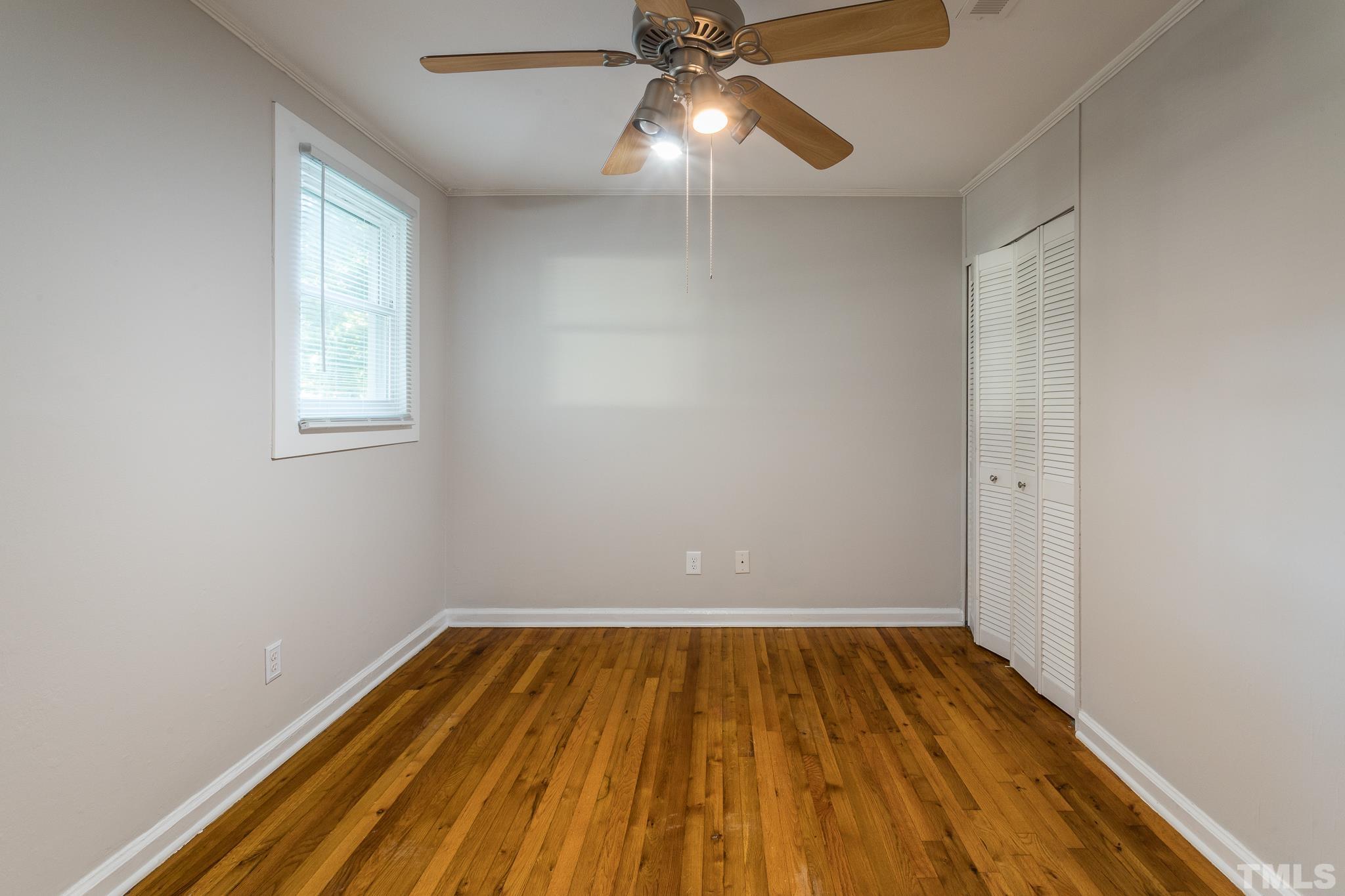 2620 McNeil Street, Unit 2620 Raleigh, NC 27608 - Photo 19 of 23 wooden floor in an empty room with a window