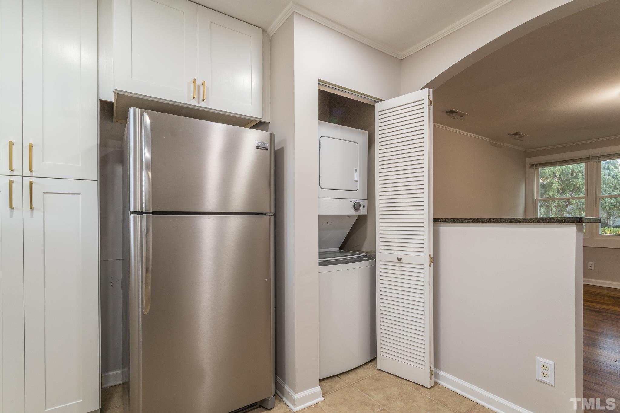 2620 McNeil Street, Unit 2620 Raleigh, NC 27608 - Photo 8 of 23 a metallic refrigerator freezer sitting in a kitchen