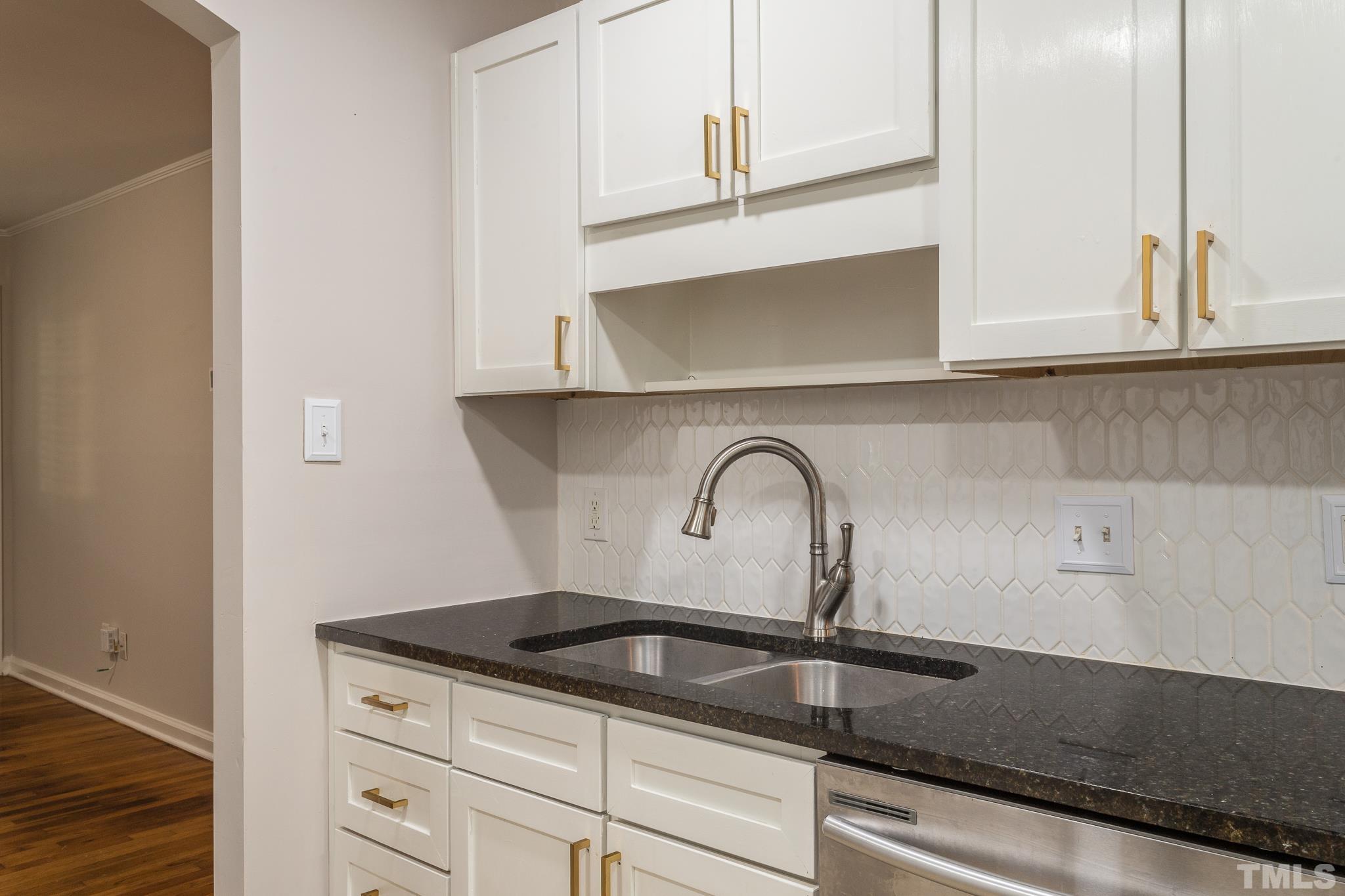 2620 McNeil Street, Unit 2620 Raleigh, NC 27608 - Photo 9 of 23 a close view of a sink a counter space and cabinets
