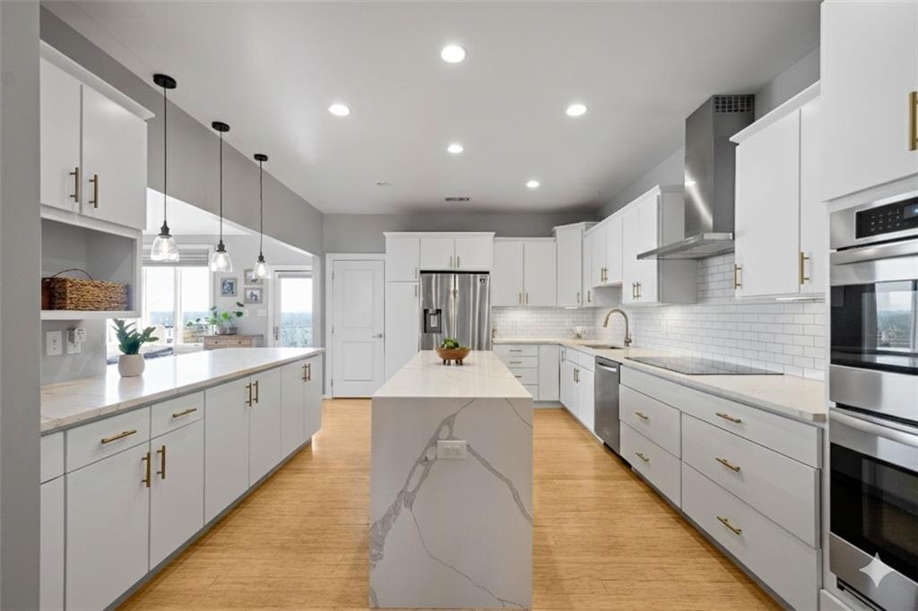 806 Harmony Road Pittsburgh, PA 15237 - Photo 13 of 48 Gleaming kitchen with Quartz counters, large island and stainless applicances. (note - this photo and 4 that follow have Ai generated backsplash because it was not completed before photos were taken. Last 2 are not Ai enhanced.)