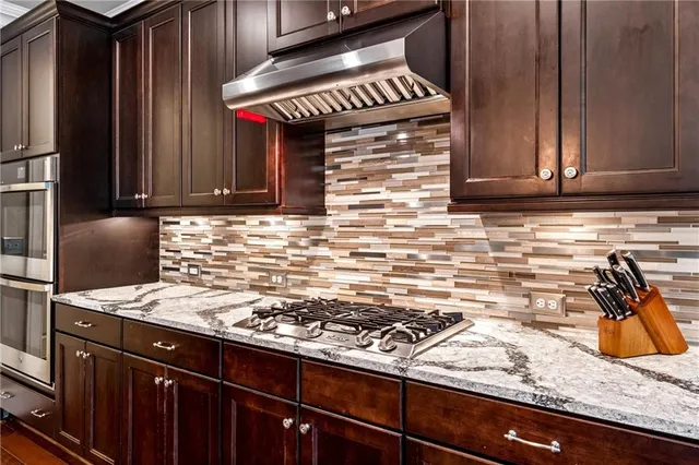 a kitchen with a stove and a refrigerator
