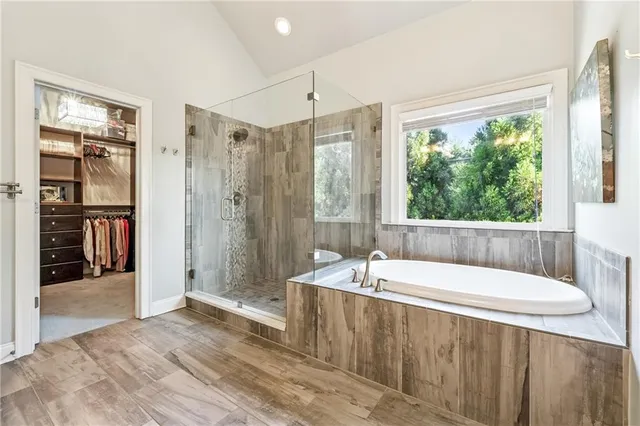a bathroom with a tub a sink and a shower