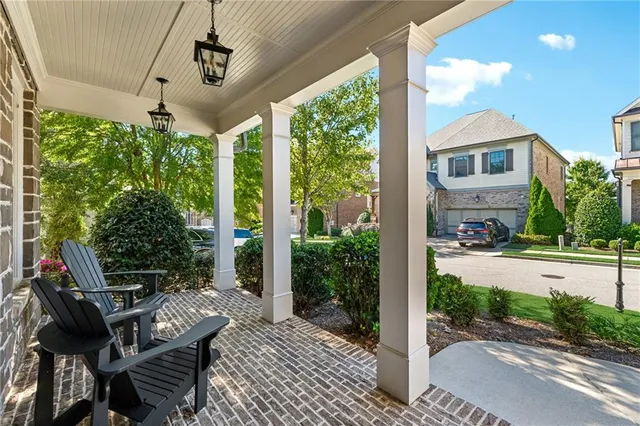 a view of a patio with table and chairs and potted plants