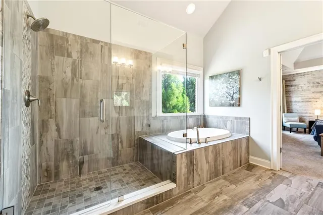 a bathroom with a tub sink and mirror