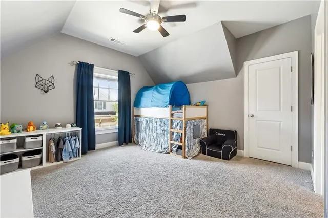 a view of a livingroom with furniture and a ceiling fan