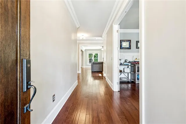 a view of a hallway with wooden floor and furniture