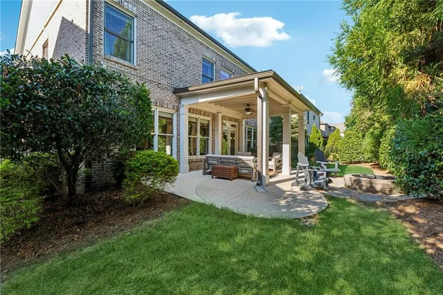 a view of a chair and table in backyard of the house