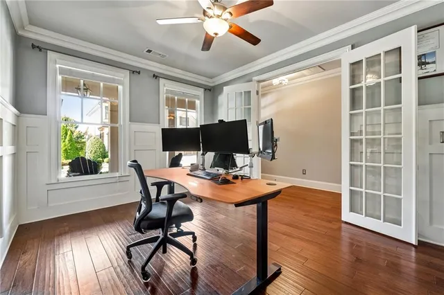 a view of a workspace with furniture and a window