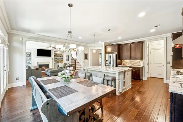 a open kitchen with stainless steel appliances granite countertop a stove refrigerator and a view of living room