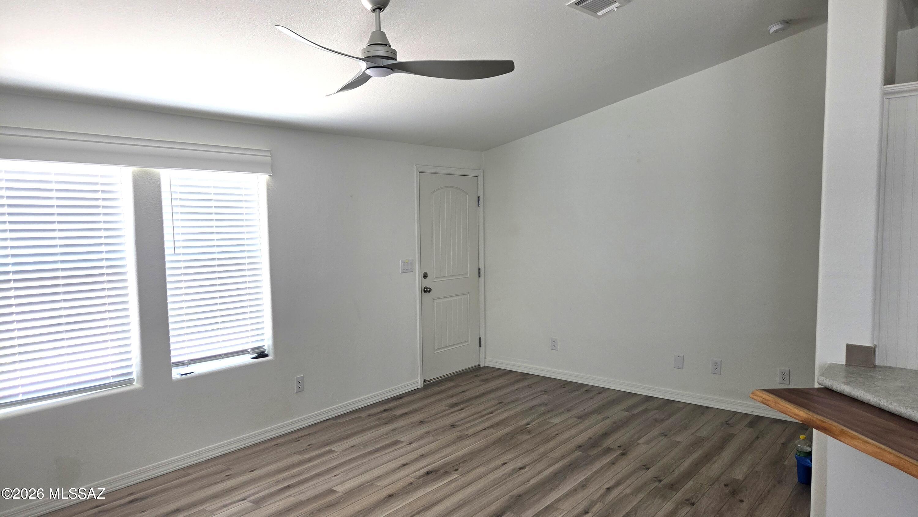 1030 Barrel Cactus Ridge, Unit 118 Benson, AZ 85602 - Photo 8 of 22 a view of a room with wooden floor and windows