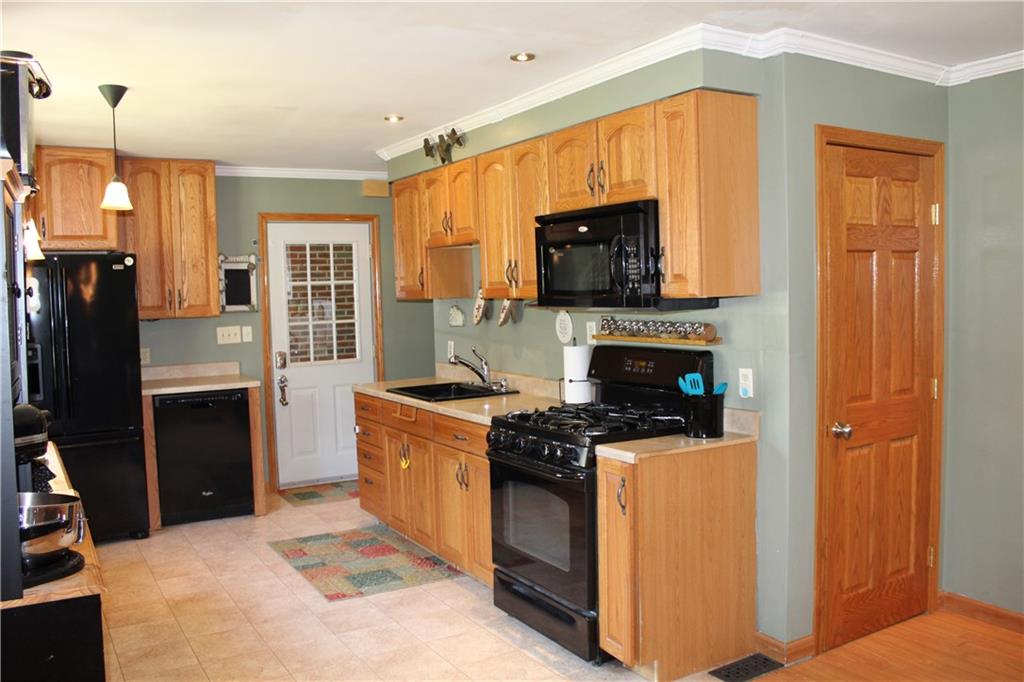 1957 Brodhead Road Aliquippa, PA 15001 - Photo 4 of 19 Fully functional kitchen making every day home living and entertaining a breeze. Large pantry behind the wooden door. Recessed lighting, crown molding and bay window gives great lighting throughout the day.