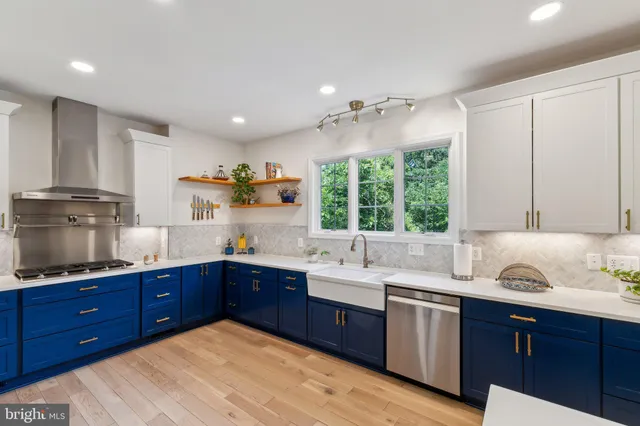 a kitchen with granite countertop a sink cabinets and window
