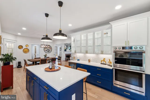 a kitchen with a sink a stove and chairs
