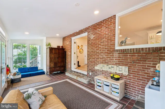 a living room with blue lights with furniture and a window
