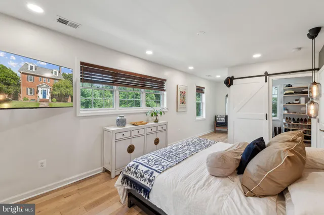 a bedroom with a large bed and a window
