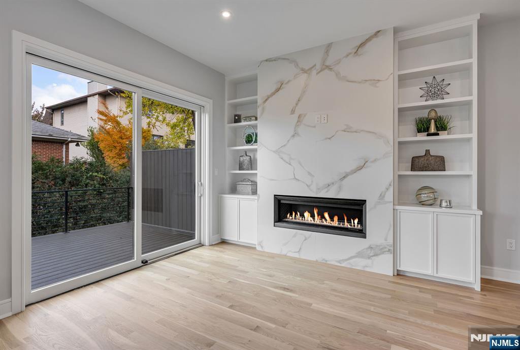 2449 Camner Street Fort Lee, NJ 07024 - Photo 11 of 47 a living room with a fireplace and a floor to ceiling window
